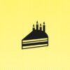 Yellow surface with an abstract, graphic representation of a piece of cake with four burning candles.