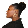A photo of Mable Preach in profile, she has gold earrings on and a black blouse.