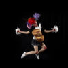 A deep black background in front of which a white woman in a short black dress jumps up happily. She holds two mops in her hand like cheerleader pom-poms and has bloody knees. A huge loaf of bread is stuck in front of her stomach.