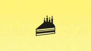 Yellow surface with an abstract, graphic representation of a piece of cake with four burning candles.