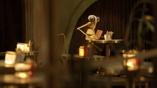 The Mosquito puppet sits in the setting of a small, cozy bistro and reads a menu. Candles glow hazily on the tables.