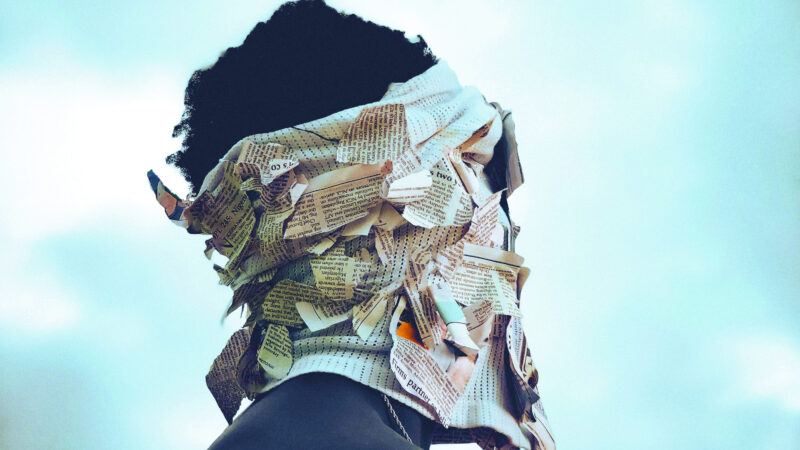 Nordwind Festival main motif. A person is shown in profile with a newspaper wrapped around their head.